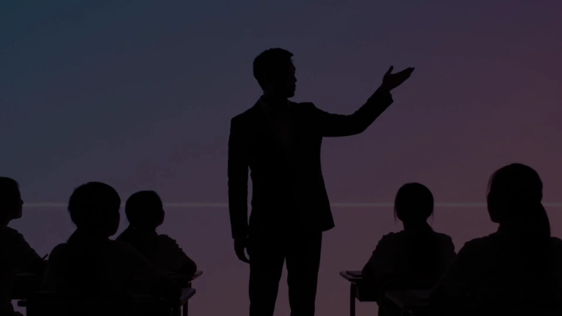 Silhouette of a teacher presenting to a classroom